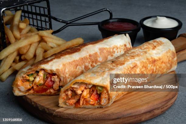 chicken fajita sandwich,close-up of wrap sandwich on cutting board,united arab emirates - wrapped burrito stock pictures, royalty-free photos & images