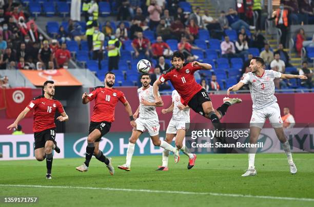 Ahmed Hegazy of Egypt jumps for a header during the FIFA Arab Cup Qatar 2021 Semi-Final match between Tunisia and Egypt at Stadium 974 on December...