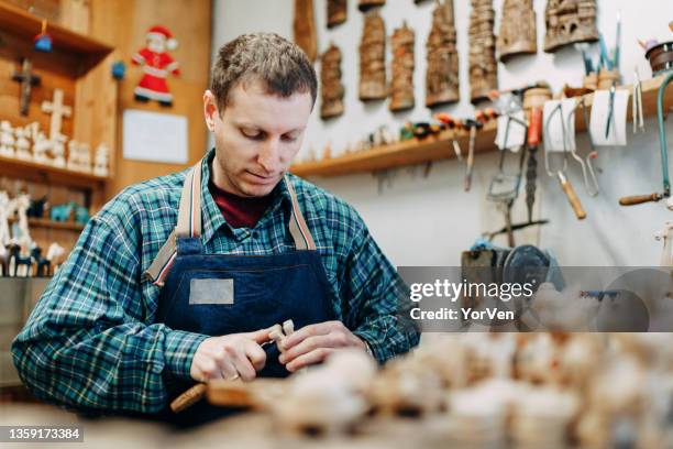 craftsman shaping wood into small souvenir - carve out stock pictures, royalty-free photos & images