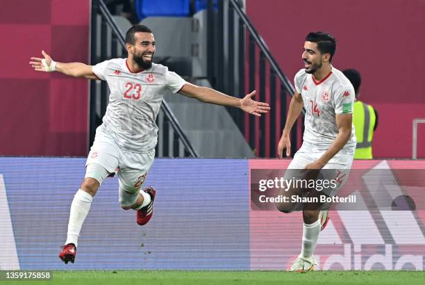 Naim Sliti and Mohamed Ben Hmida of Tunisia celebrate after their team's first goal, an own goal scored by Amro Elsoulia of Egypt during the FIFA...