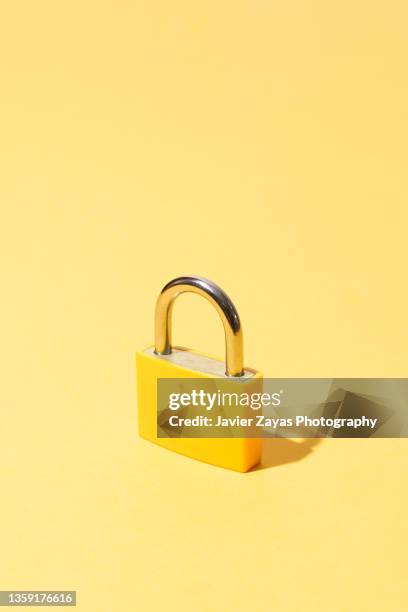 yellow padlock on yellow background - password strength stock pictures, royalty-free photos & images
