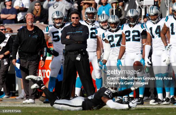 Ron Rivera, head coach of the Carolina Panthers, watches as the Oakland Raiders' DJ Hayden comes up short on a pass interception at the Coliseum in...