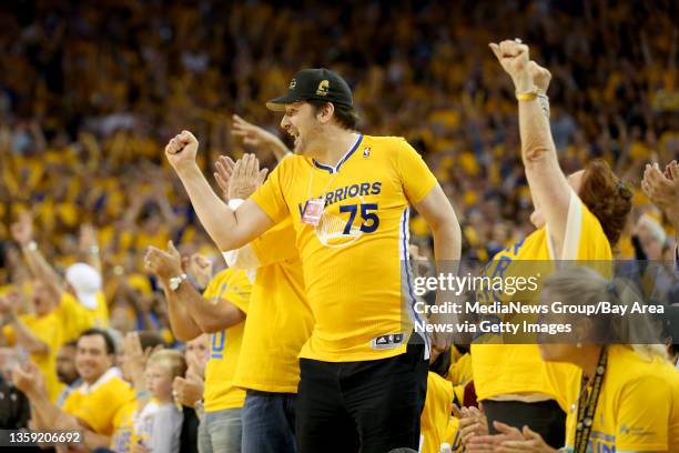 The Golden State Warriors fans celebrate a basket as the Warriors are one point behind after coming back from a 20-point deficit against the San...