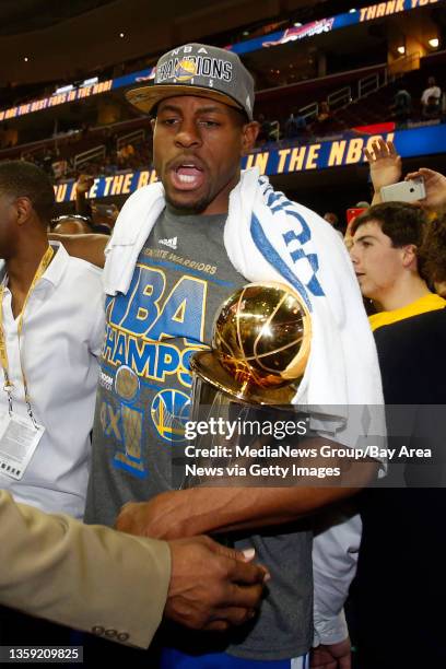 Golden State Warriors' Andre Iguodala carries the MVP trophy after defeating the Cleveland Cavaliers in Game 6 of the NBA Finals at Quicken Loans...