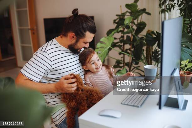 padre e hija trabajando juntos en casa - family children dog fotografías e imágenes de stock
