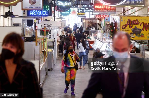 People wear face coverings inside Grand Central Market on December 15, 2021 in Los Angeles, California. California residents, regardless of COVID-19...