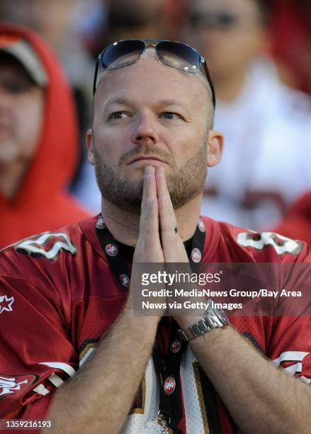 San Francisco 49ers' fan prays after the New Orleans Saints scored in the fourth quarter of the NFC divisional playoff game on Saturday, Jan. 14 at...