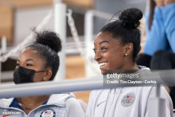 Simone Biles of the United State in the stands with team mate Jordan Chiles watching the All-Around Final for Women at Ariake Gymnastics Centre...