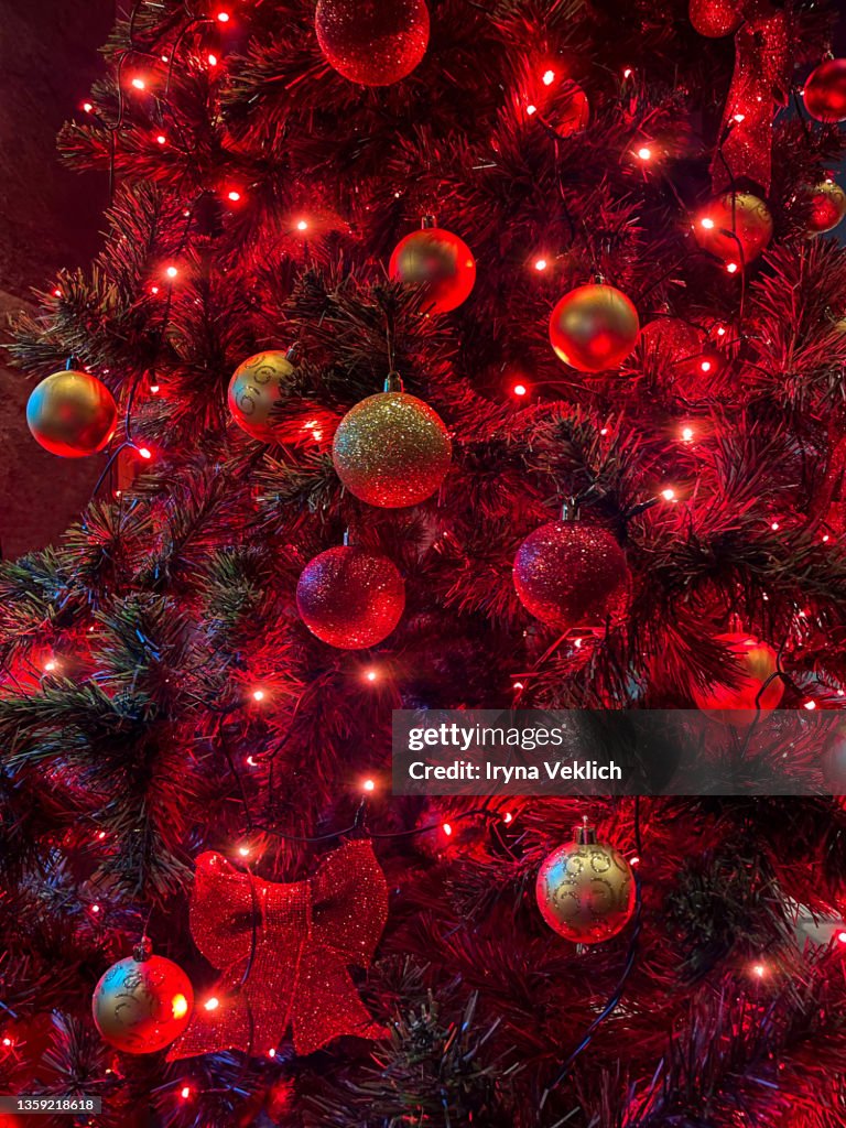 Christmas tree decorations with baubles in red color.