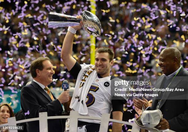 Baltimore Ravens quarterback Joe Flacco raises the Vince Lombari trophy after winning Super Bowl XLVII at the Superdome in New Orleans on Sunday,...