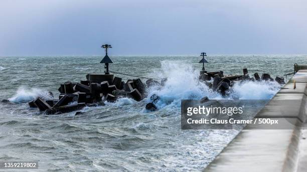 man standing on pier over sea against sky,helgoland,germany - helgoland stock-fotos und bilder