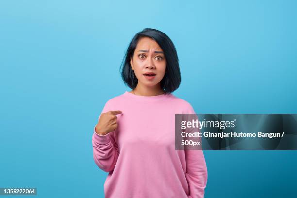 shocked asian woman portrait asking question and pointing at herself,indonesia - surprise portrait photos et images de collection