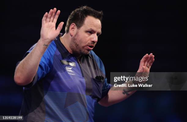 Adrian Lewis of England reacts during his First Round match against Matt Campbell of Canada during the William Hill World Darts Championship at...