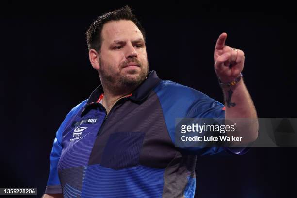 Adrian Lewis of England reacts during his First Round match against Matt Campbell of Canada during the William Hill World Darts Championship at...