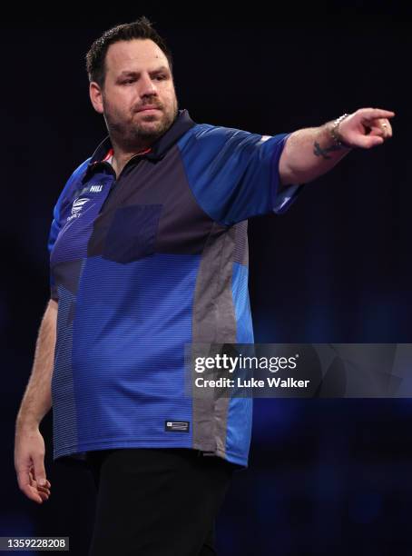 Adrian Lewis of England reacts during his First Round match against Matt Campbell of Canada during the William Hill World Darts Championship at...