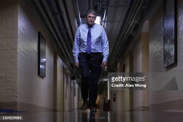 Sen. Joe Manchin walks through a hallway in the basement of the U.S. Capitol December 15, 2021 in Washington, DC. President Joe Biden said on...