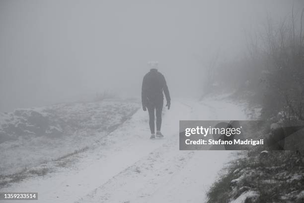 person in winter during snowfall on the mountain road - sleet bildbanksfoton och bilder