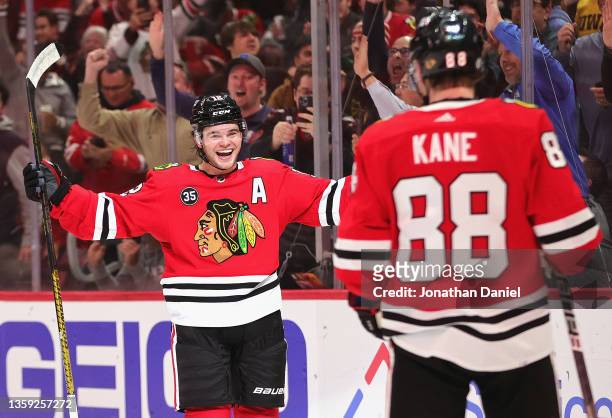 Alex DeBrincat of the Chicago Blackhawks celebrates a second period, power play goal with Patrick Kane against the Washington Capitals at the United...