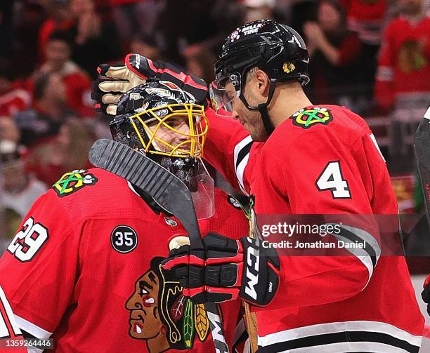 Seth Jones of the Chicago Blackhawks celebrates a win over the Washington Capitals with Marc-Andre Fleury at the United Center on December 15, 2021...