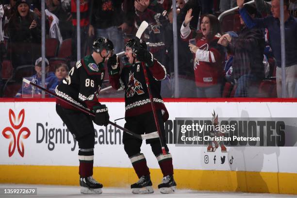 Clayton Keller of the Arizona Coyotes celebrates with Anton Stralman after scoring a power-play goal against the New York Rangers during the third...