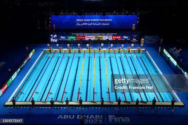 Competitors compete in the Men's 400m Freestyle heats during day one of the FINA World Swimming Championships Abu Dhabi at Etihad Arena on December...