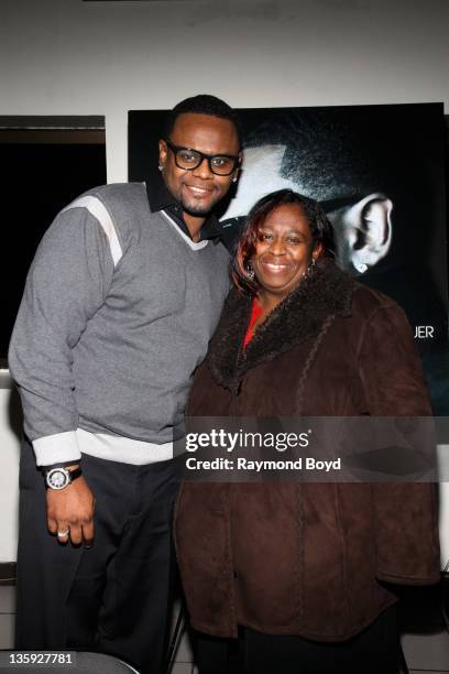 Singer Carl Thomas poses for a photo with his sister Gail Evans, during "The Experience With Carl Thomas" at the DuSable Museum in Chicago, Illinois...