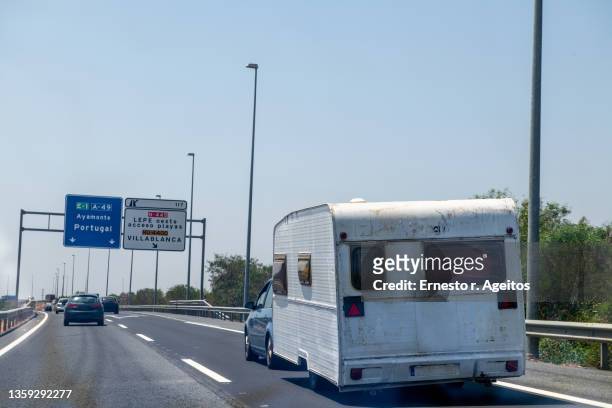 towed caravan in a spanish road on route to portugal - provincia de huelva stock pictures, royalty-free photos & images