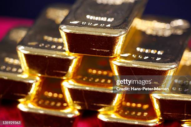 stacked gold ingots - gold bullion stock pictures, royalty-free photos & images
