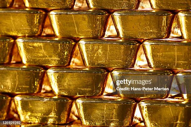 stacked gold ingots - gold bullion stockfoto's en -beelden