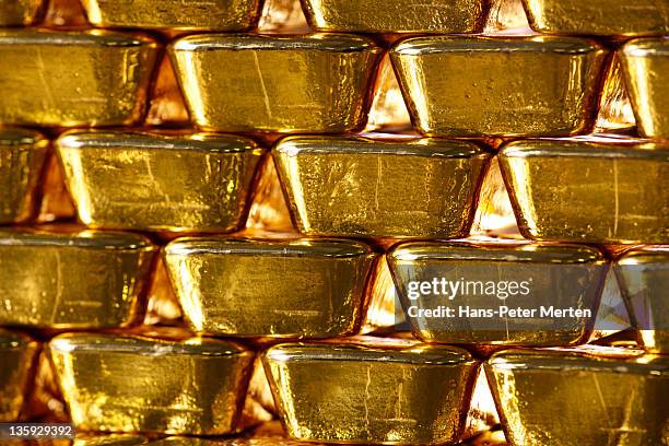 stacked gold ingots - gold bars stock pictures, royalty-free photos & images