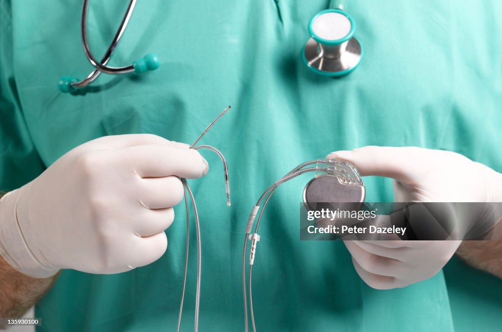 Surgeon Holding Heart Pacemaker