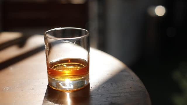 High angle shot footage of a whisky glass