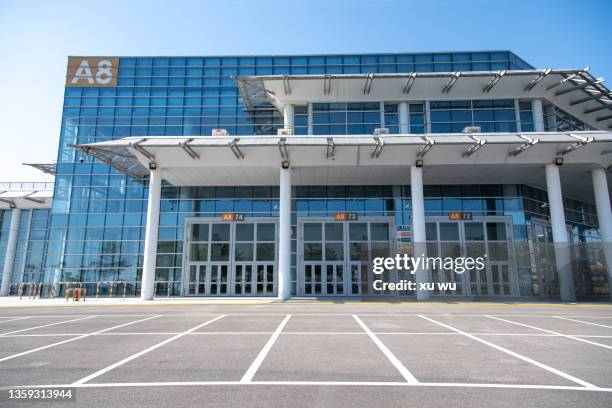 parking lot at the entrance of the exhibition hall - curtain wall facade stock pictures, royalty-free photos & images