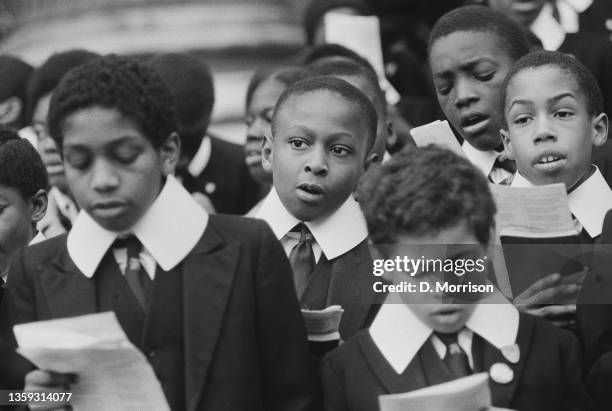 Members of the boys' choir from St Mark's Church, Dalston, singing carols on the steps of St Paul's Cathedral, as part of a Christmas appeal for Help...