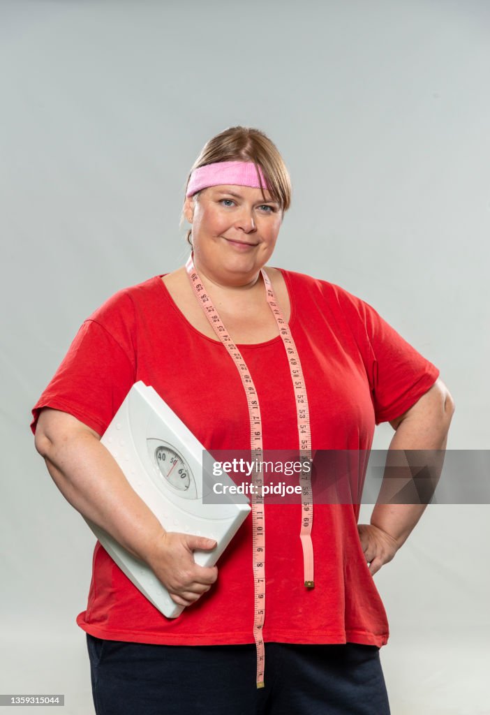 Post Christmas Dieting Proud Overweight Woman Holding Weight Scale