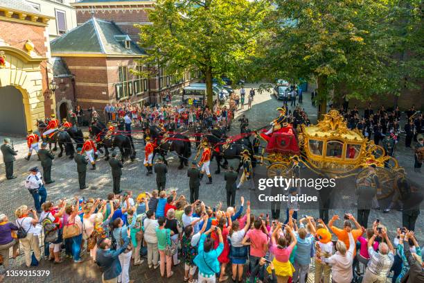 dutch royals leaving binnenhof during prinsjesdag in the hague - golden carriage stock pictures, royalty-free photos & images