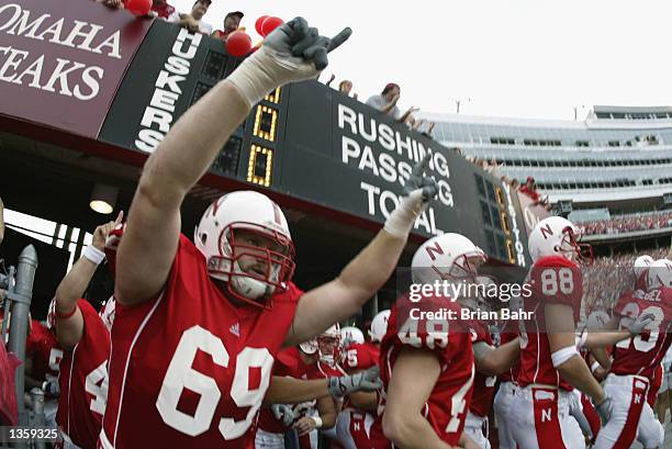 Tackle Nick Povendo of the Nebraska Cornhuskers explodes out of the tunnel before the NCAA football game against the Arizona State Sun Devils on...