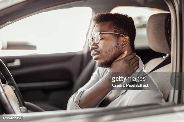 man having neck pain while driving a car - posture stock pictures, royalty-free photos & images