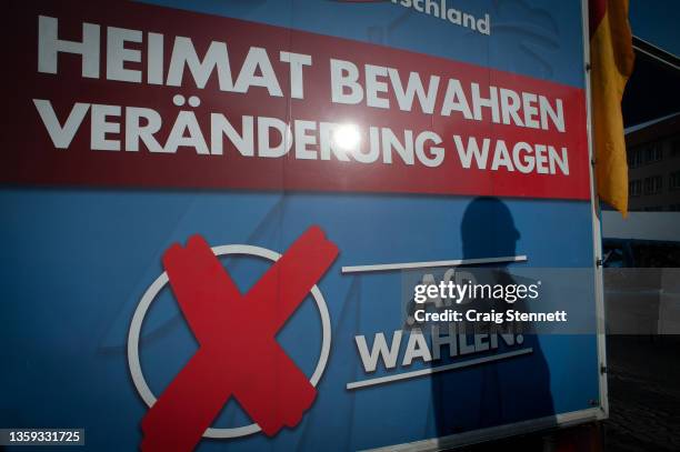 Man stands lsitening to a speech being given by the AfD politician Björn Höcke at a regional election rally on October 23, 2019 in Gotha, Thuringia,...