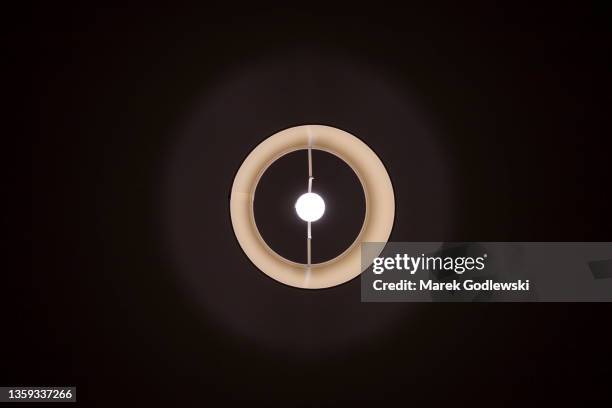 ceiling lamp shade pictured from underneath, light bulb in the lamp shade, - suspended ceiling stock pictures, royalty-free photos & images