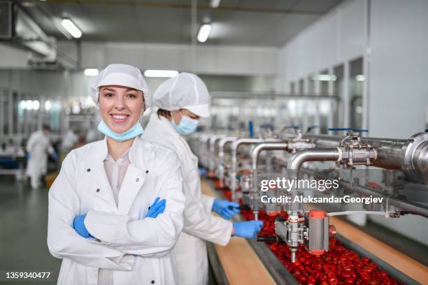 female worker displaying confidence at job position in factory making peppers with cottage cheese - food processing plant stock pictures, royalty-free photos & images