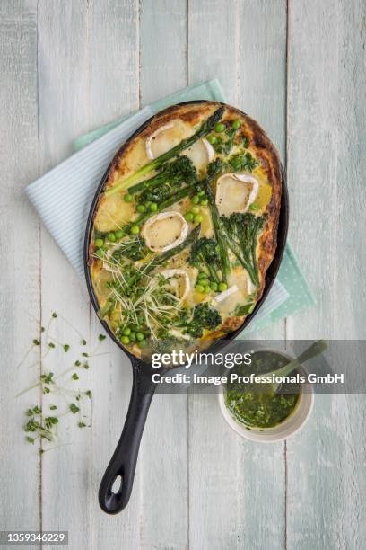 potato and egg frittata with spring vegetables and gats cheese, basil oil on a side - frittata stock pictures, royalty-free photos & images