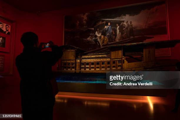 Man takes pictures of a replica of the Red Boat, the boat on which the first National Congress of the Communist Party of China was secretly held, at...