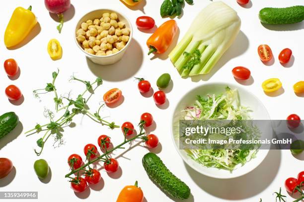 healthy salad ingredients on white background - krulandijvie stockfoto's en -beelden