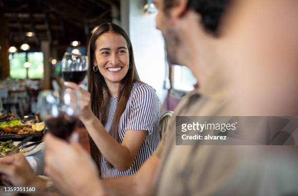 couple having wine during lunch at restaurant - argentina wine stock pictures, royalty-free photos & images