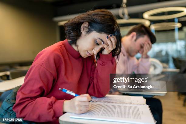 young college girl taking exam and getting stressed - forgot homework stock pictures, royalty-free photos & images