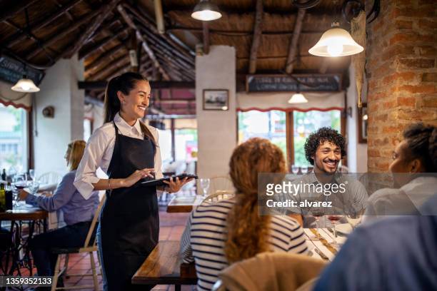 restaurant waitress taking lunch order from guests - empregada de mesa imagens e fotografias de stock
