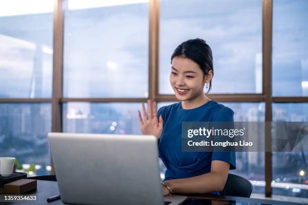 a young asian woman says hello via video - scandal press conference stock pictures, royalty-free photos & images