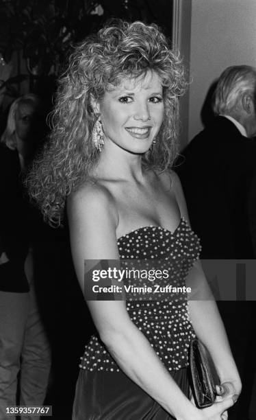 American actress Heidi Bohay wearing a polka dot tube top, attends an event, circa 1985.