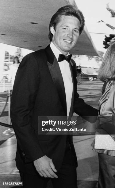 American actor Bruce Boxleitner, wearing a tuxedo and bow tie with a white shirt, attends an event, circa 1985.